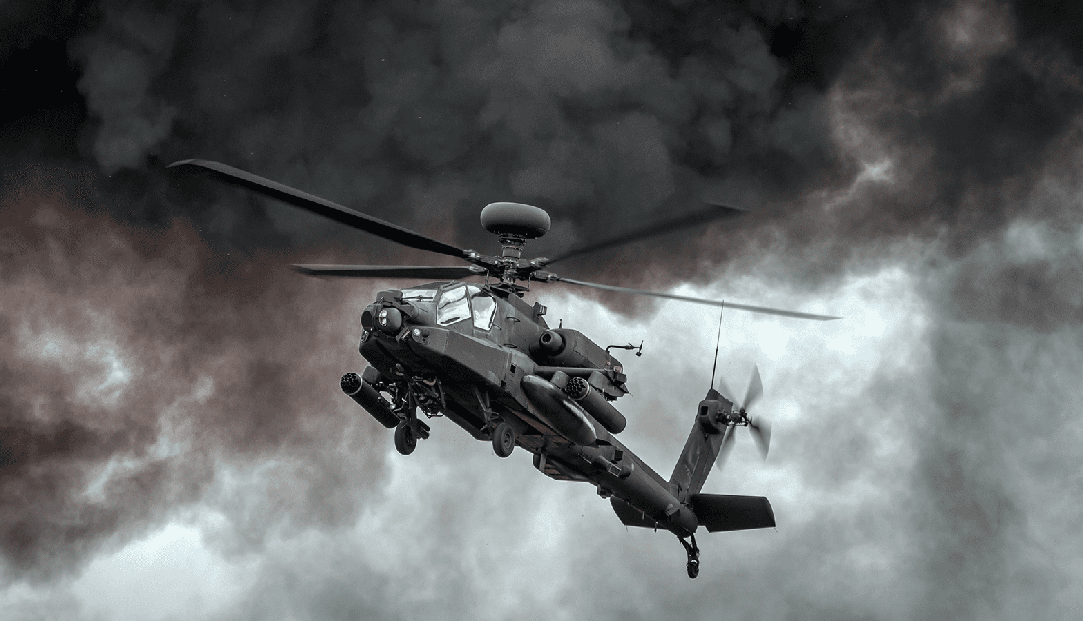 AH-64 flying in air with dark smoke in the background